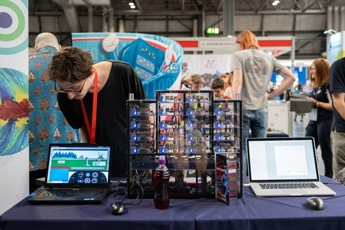 EPCC stand at BBF. Photo shows EPCC colleague standing beside Wee Archie mini supercomputer and 2 laptops.