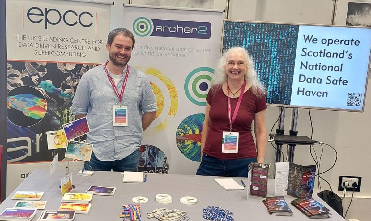 A man and a woman at an exhibition stand.