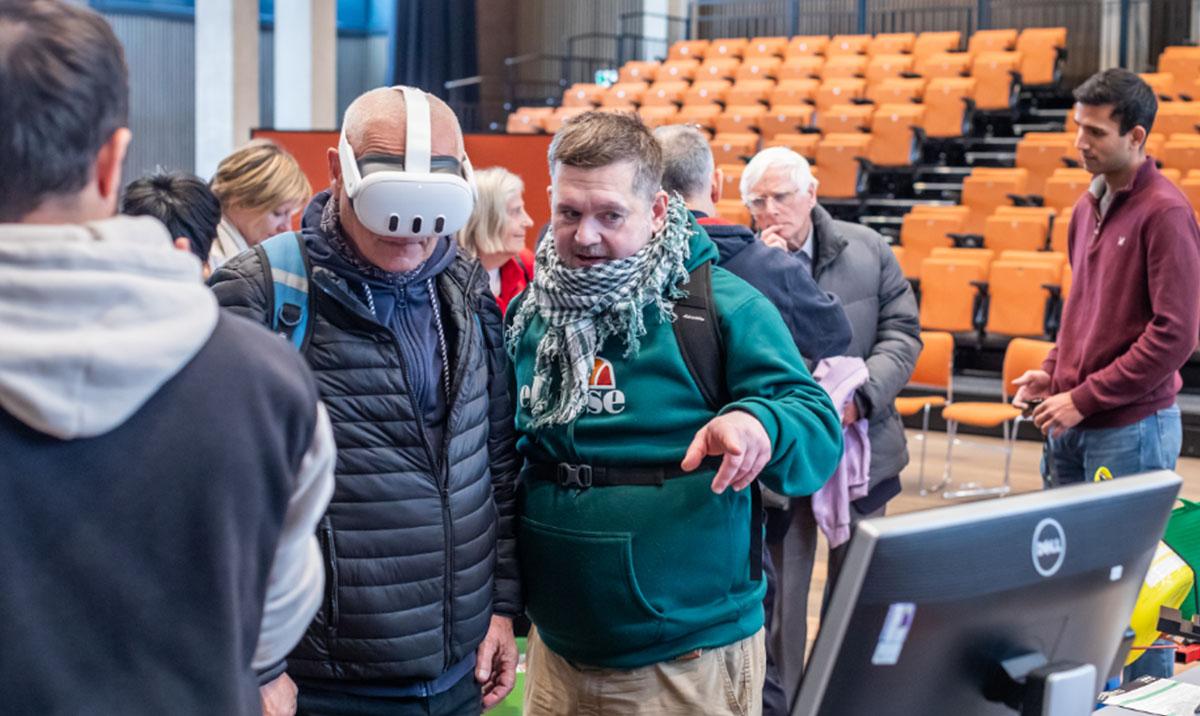 Photo shows people trying tasks at a science festival. Image by Chris Scott.