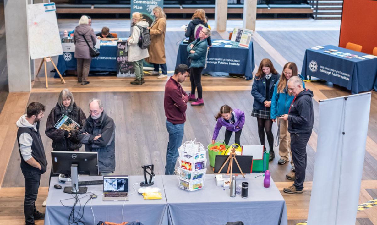 Photo shows people trying tasks at a science festival. Image by Chris Scott.