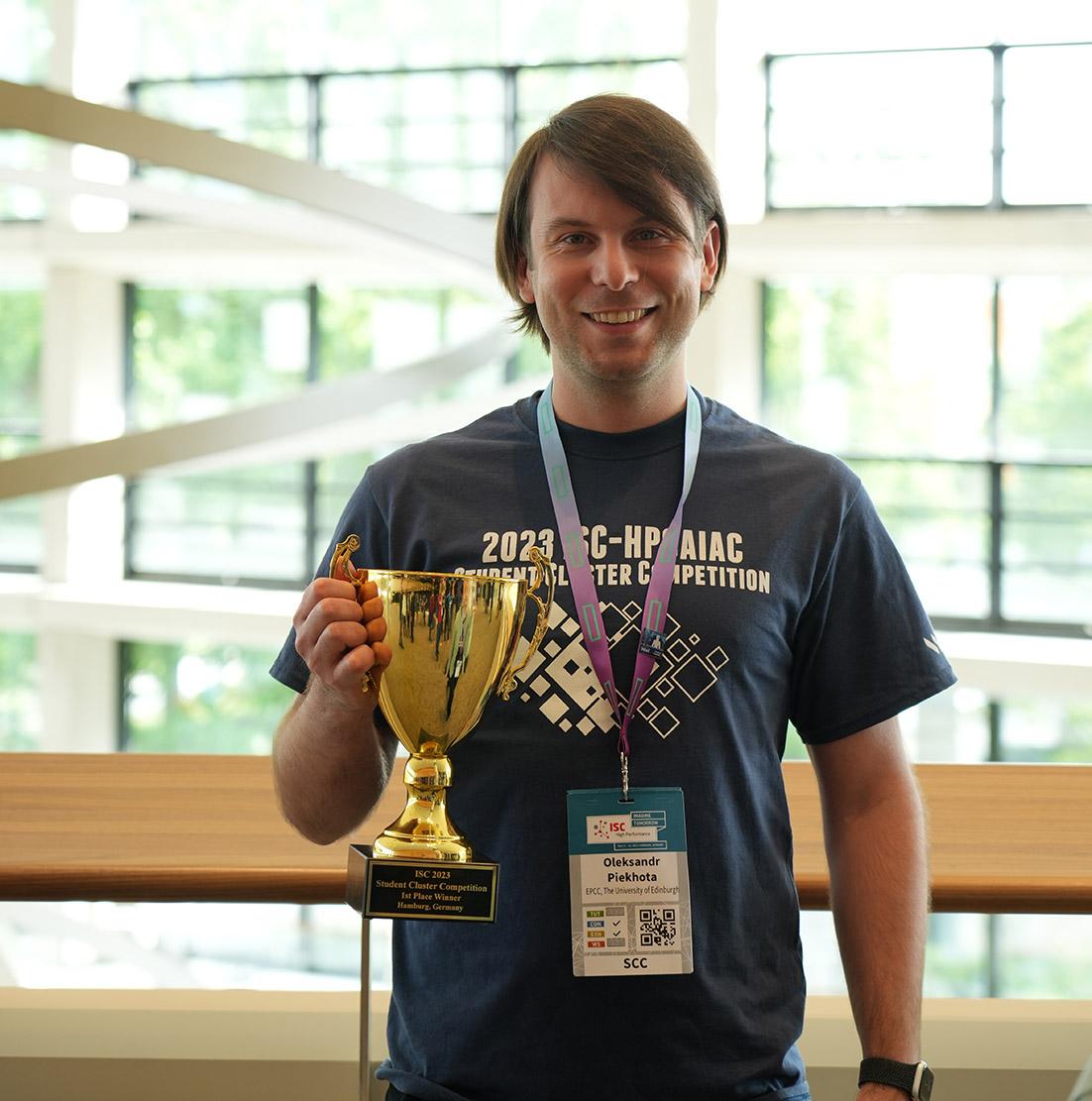 Young man holding trophy cup