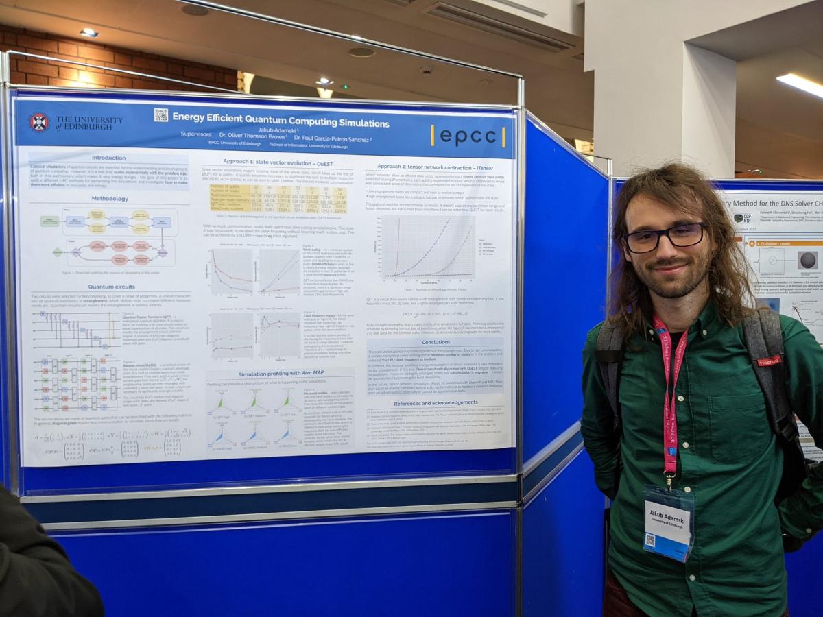 Jakub Adamski standing beside his award-winning poster