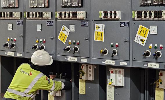 High voltage specialist removing a 11000Volt circuit breaker for inspection and maintenance.